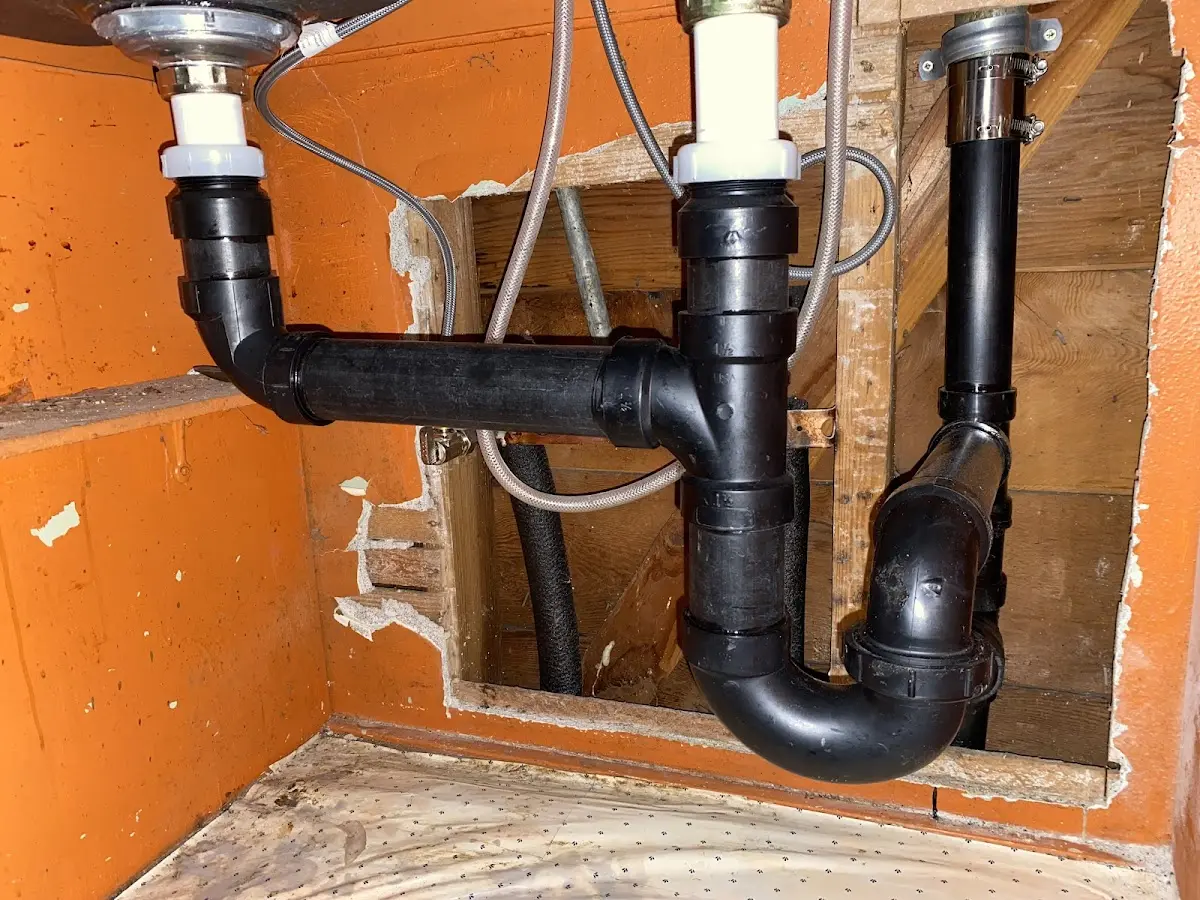 Professional Garbage Disposal Repair equipment and tools on the job in Garrison